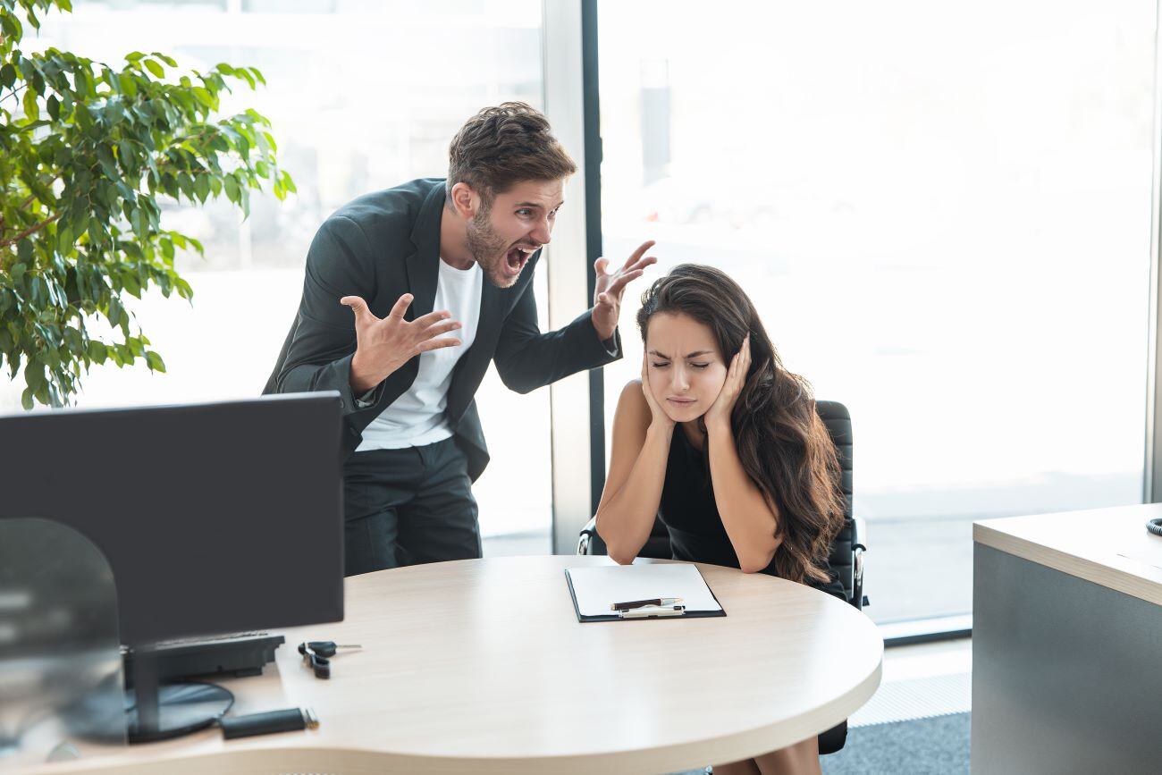 strict boss man swearing at depressed employee woman 